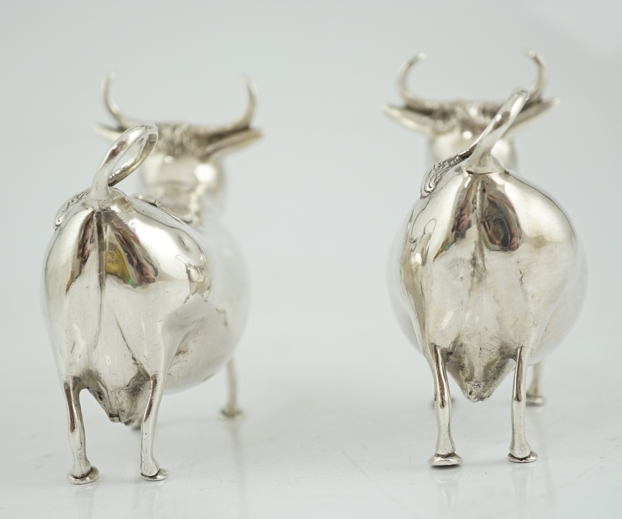 A pair of early 20th century continental silver cow creamers, by Berthold Muller
